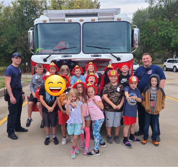 class in front of a fire truck 