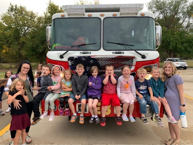 kindergarten class standing in front of a fire truck
